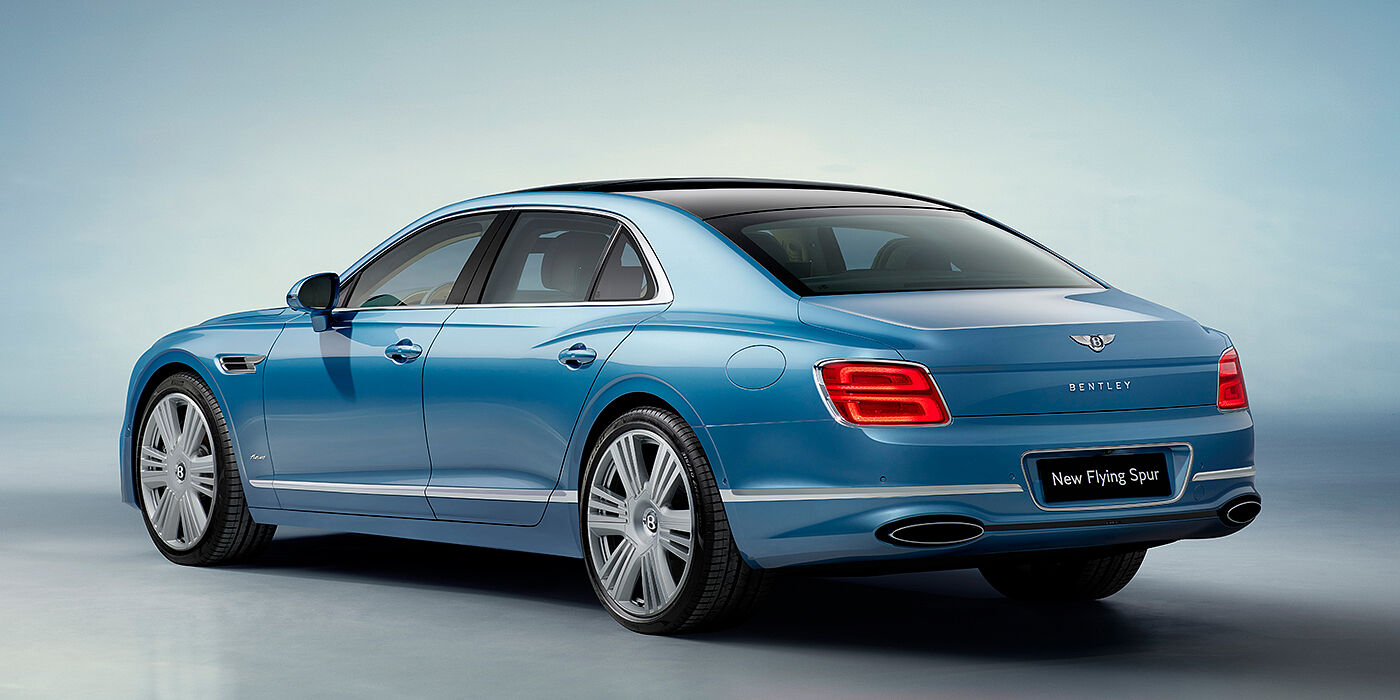 Bentley Lisboa New Bentley Flying Spur Azure sedan rear view in Light windsor blue by Mulliner paint with 22 inch Azure wheels and chrome exterior details