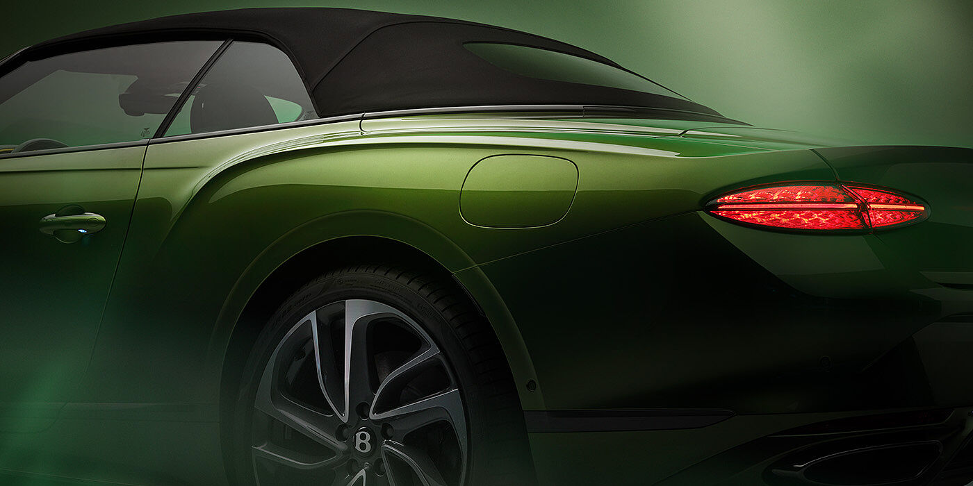 Bentley Lisboa Bentley New Continental GTC Speed rear haunch and tail lamp in Tourmaline Green paint and dark tint brightware with black hood up and illuminated head lamps