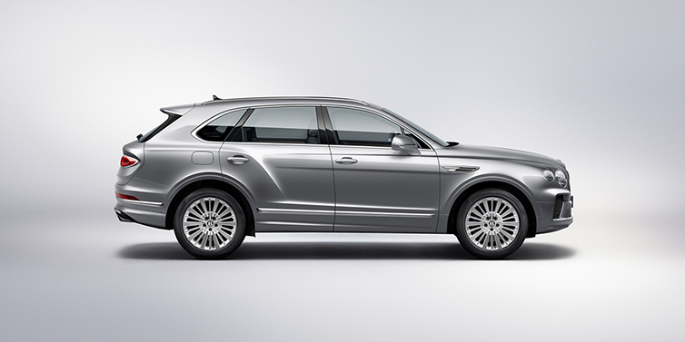 Bentley Lisboa Bentley Bentayga SUV side profile in Moonbeam silver paint against white background featuring 21 inch 5 spoke wheels